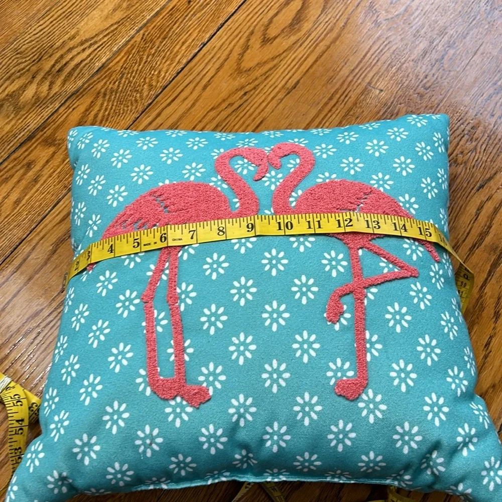 Aqua fabric pillow with hook and loop flamingo decoration.